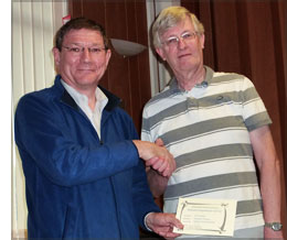 Alastair Taylor presented with certificate by Howard Bagshaw